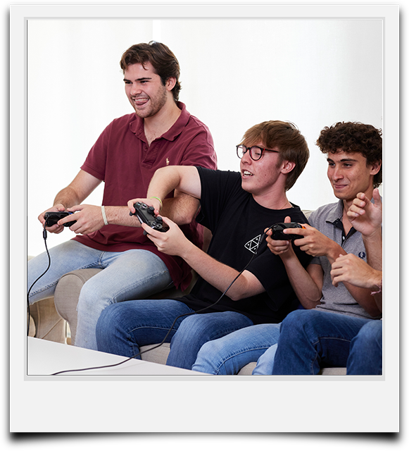 un grupo de amigos se divierte jugando a videojuegos en el salón de su apartamento en Pamplona